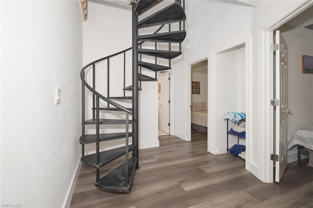 Stairway featuring dark wood-type flooring