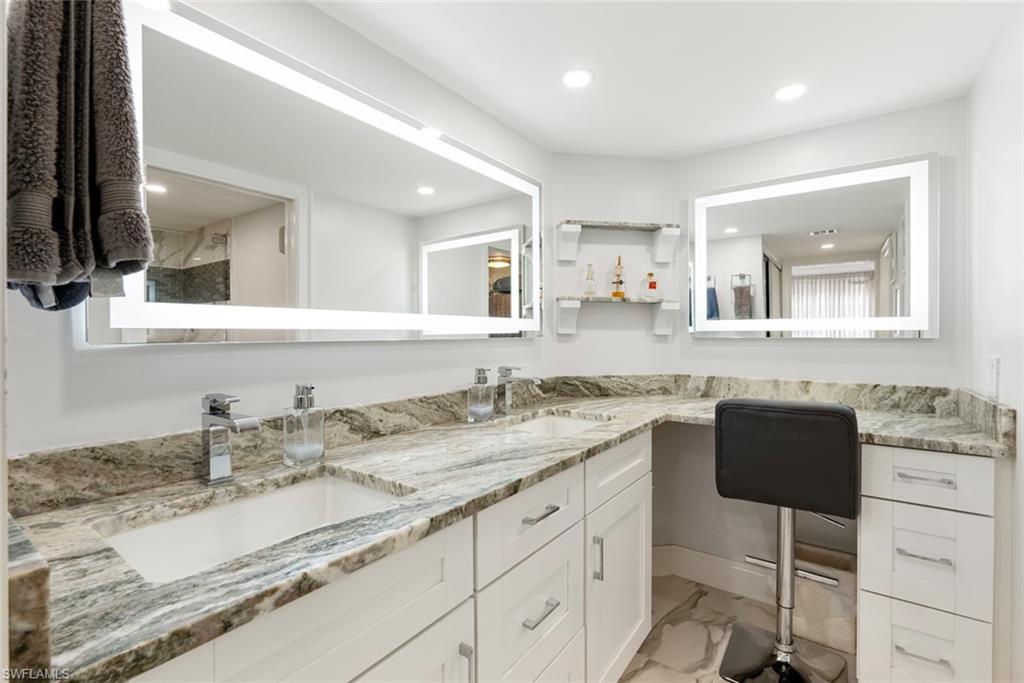 Bathroom featuring tile floors, dual sinks, and oversized vanity