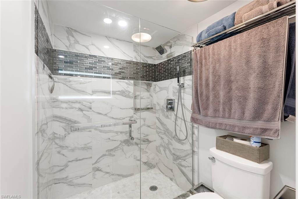 Bathroom with a shower with door and toilet