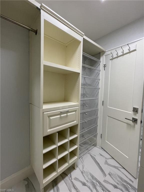 View of spacious primary closet.  All space has functional storage
