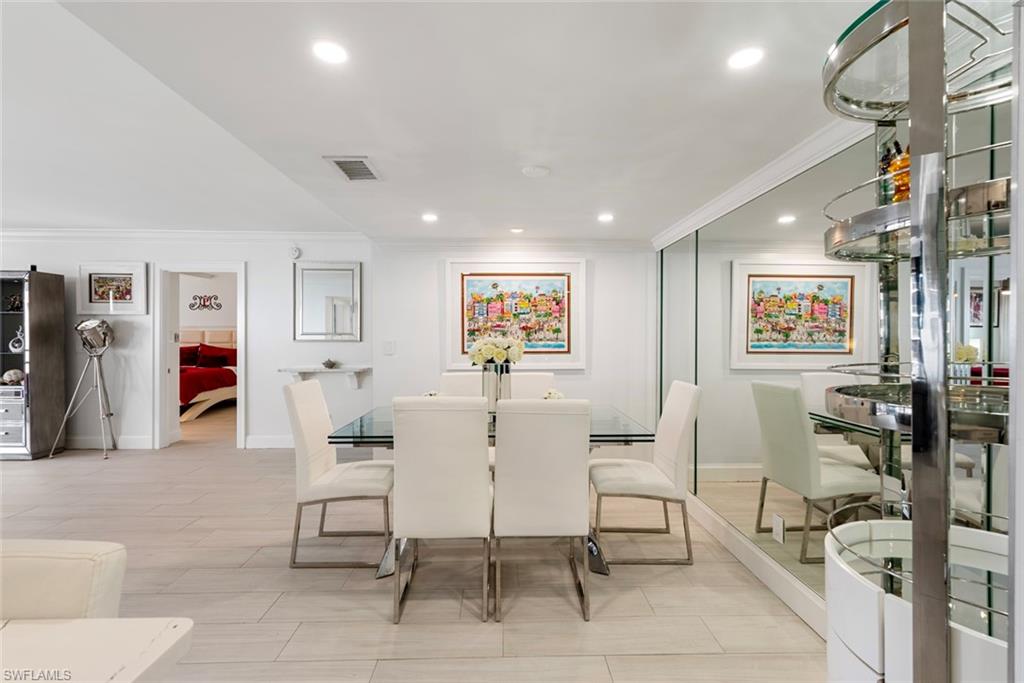 Dining space featuring crown molding and light wood-type flooring