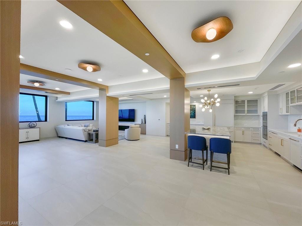 Building community room featuring beam ceiling and recessed lighting