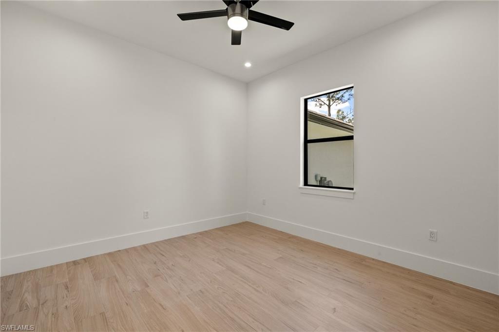 Spare room featuring ceiling fan, recessed lighting, light wood-style floors, and baseboards