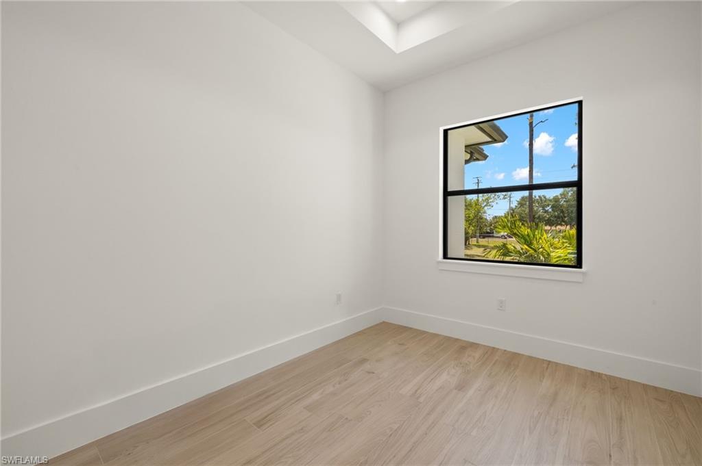 Empty room featuring baseboards and light wood finished floors