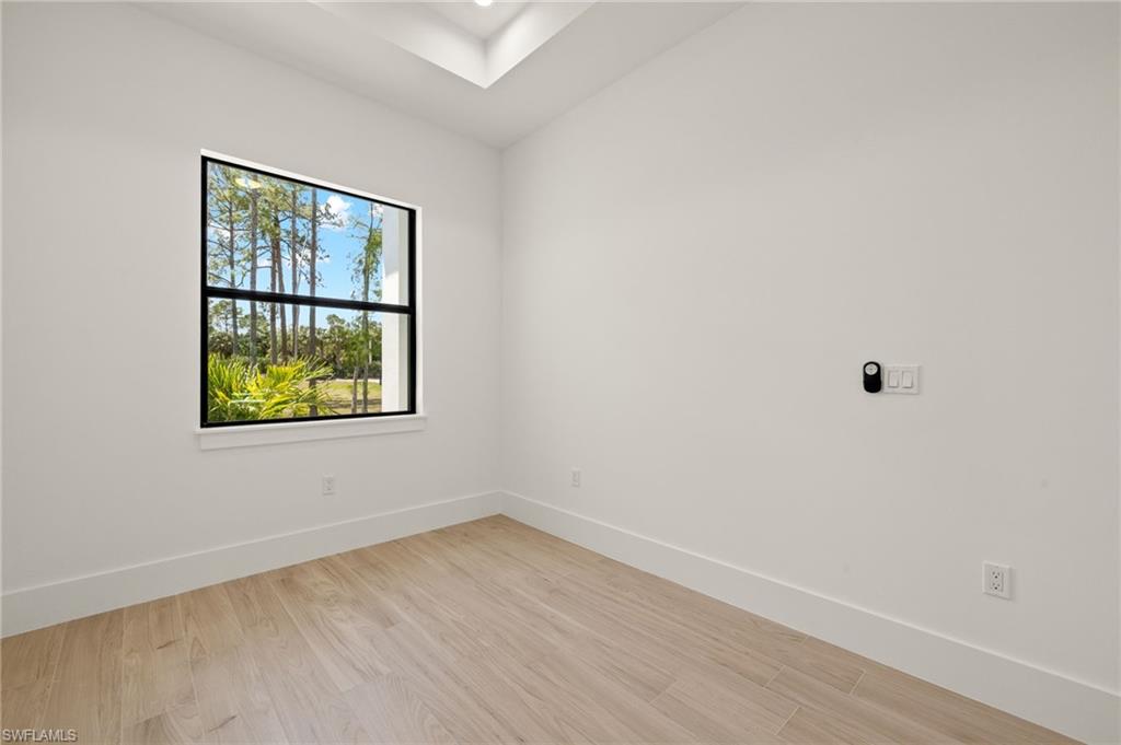 Empty room featuring light wood finished floors and baseboards
