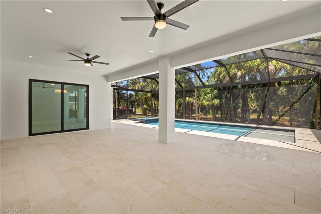 Pool with a patio, a lanai, and a ceiling fan