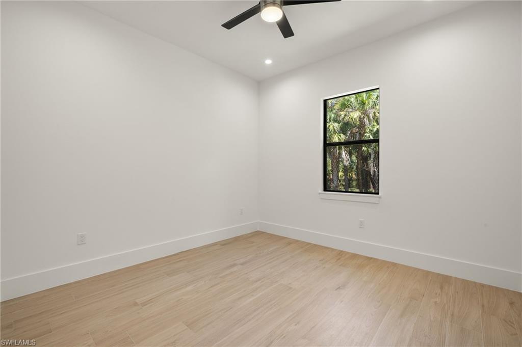 Empty room featuring light wood-style floors, baseboards, a ceiling fan, and recessed lighting