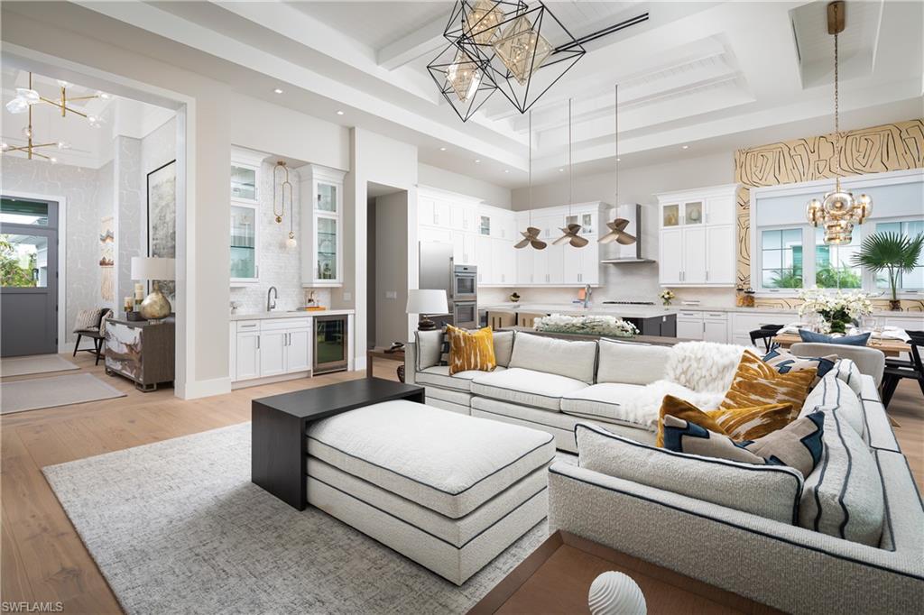 Living room featuring a chandelier, sink, wine cooler, and light hardwood / wood-style flooring