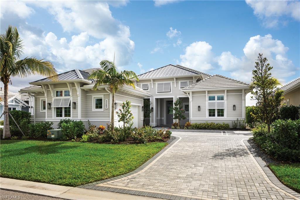 View of front of house with a garage and a front yard