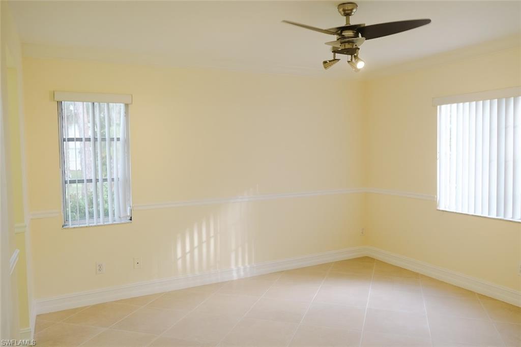 Unfurnished room with ceiling fan and light tile patterned flooring