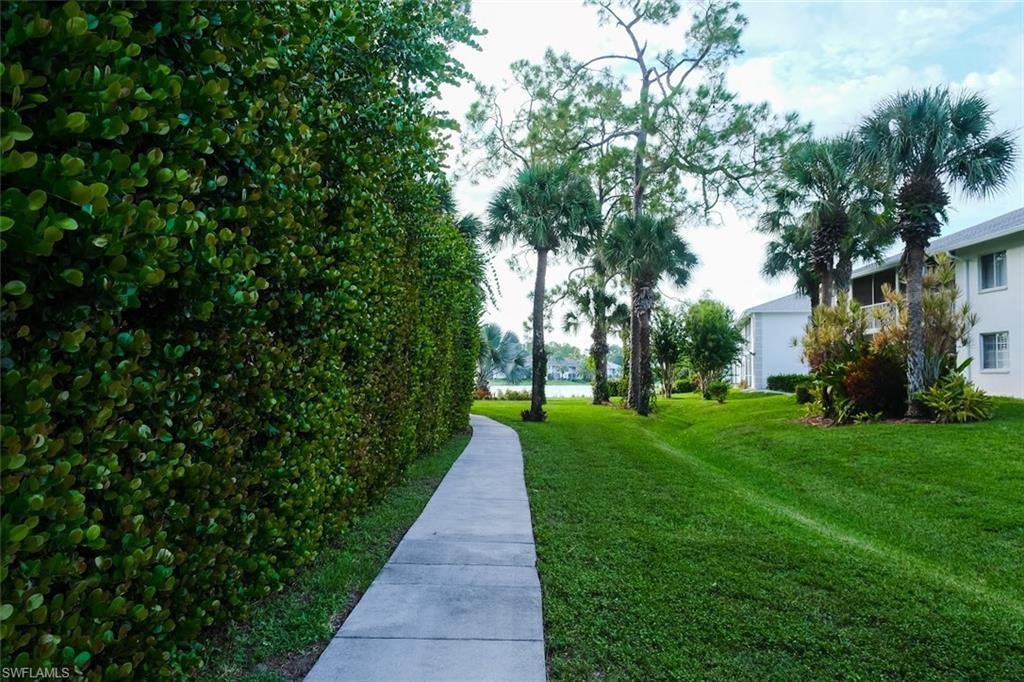 View of property's community featuring a yard