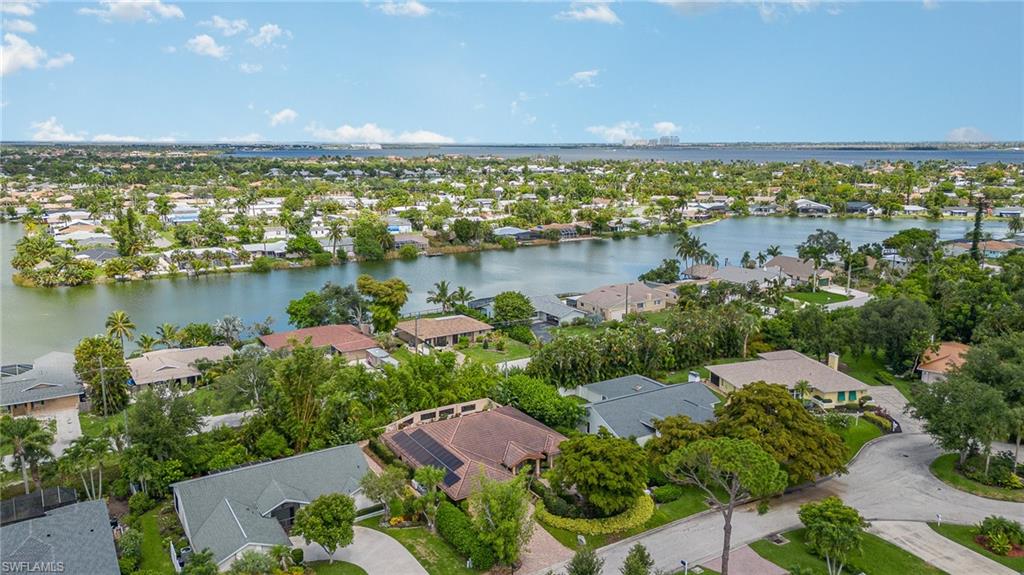 Birds eye view of property with a water view