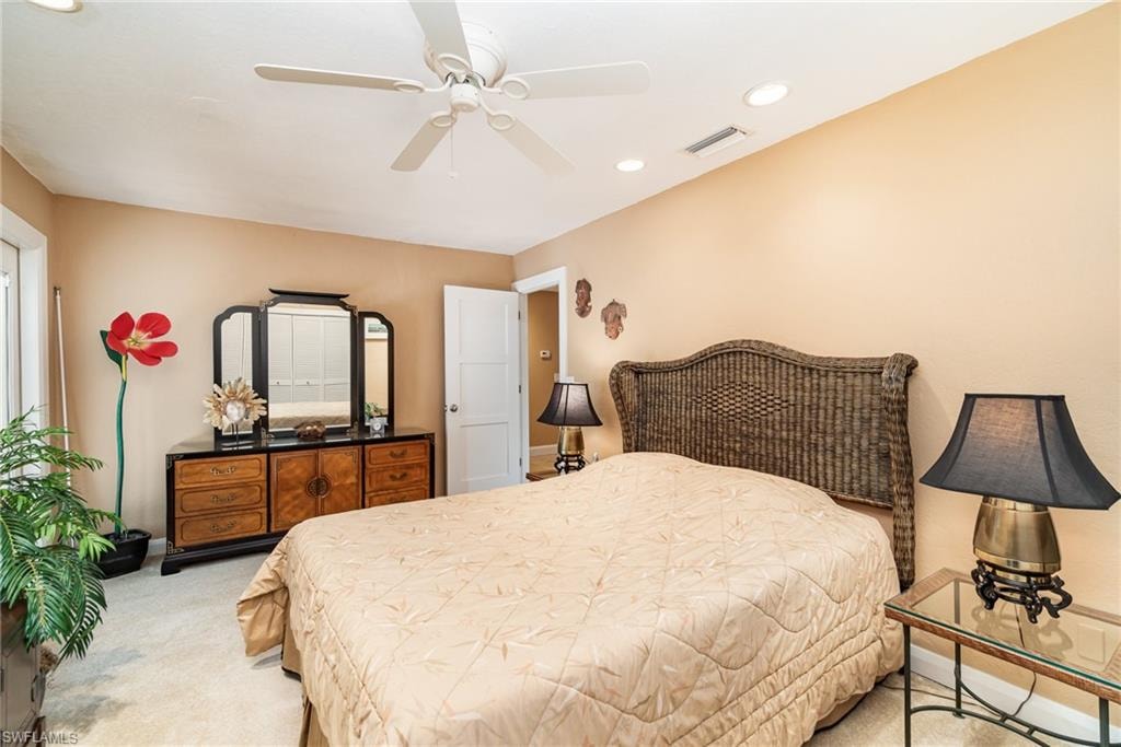 Bedroom featuring light carpet and ceiling fan