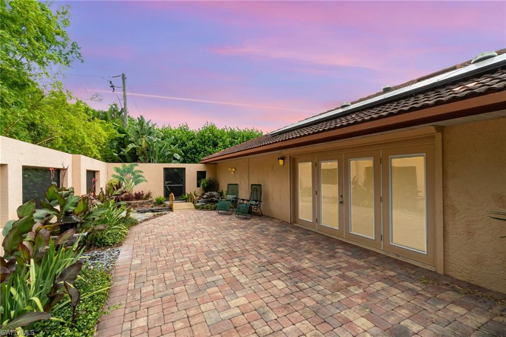 Patio terrace at dusk with french doors