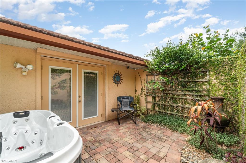 View of patio / terrace with a hot tub