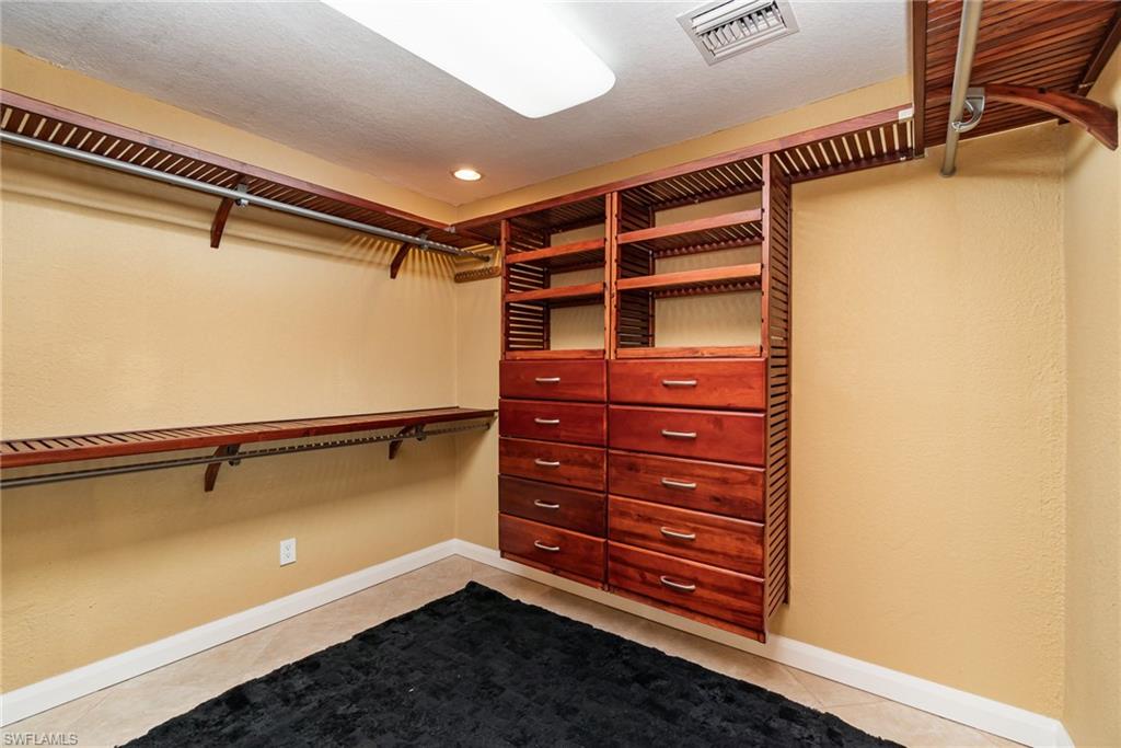 Spacious closet with light tile flooring