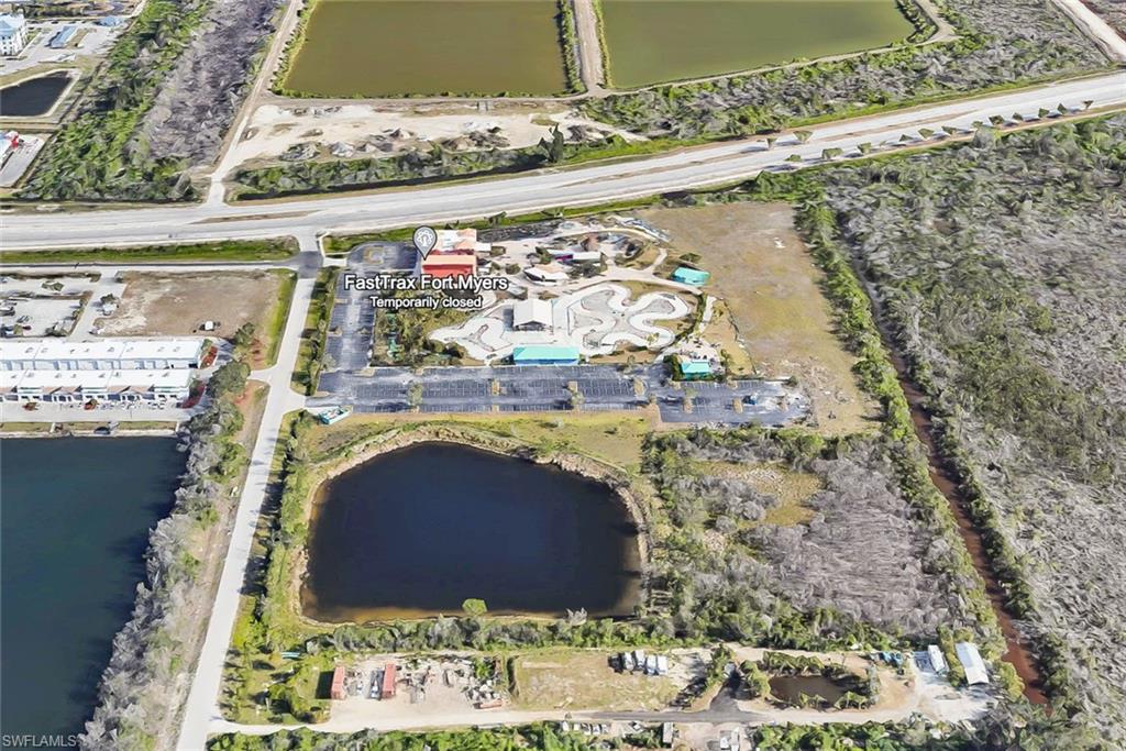 Birds eye view of property with a water view