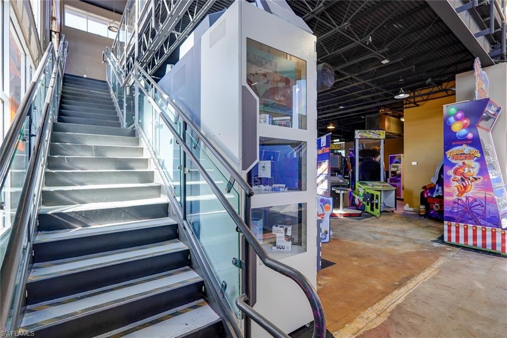 Staircase featuring concrete flooring