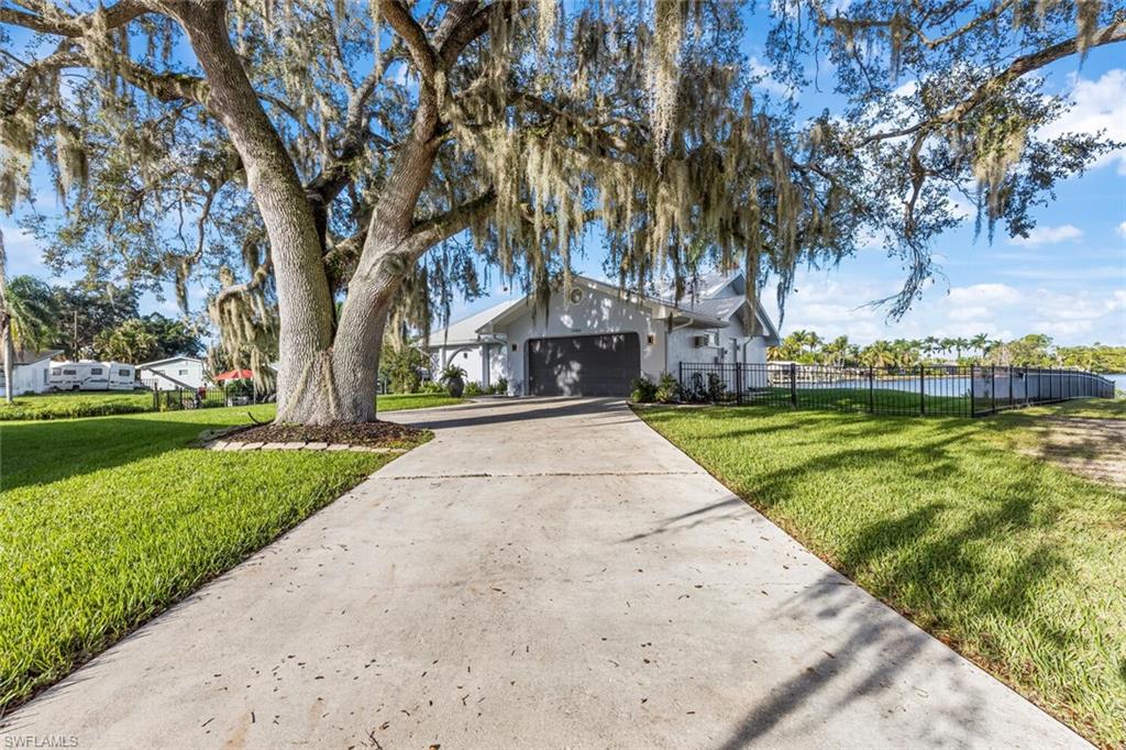 Magnificent live oak tress with Spanish moss.  Very dramatic entrance to this home.  Spacious 2-car garage.  Longer driveway for plenty of guests.