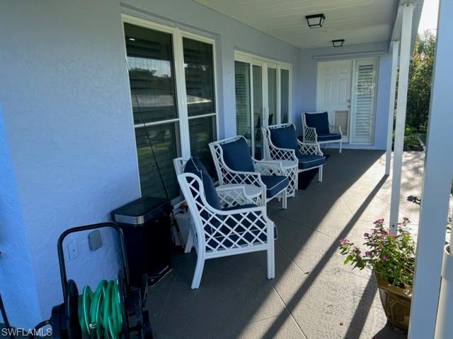 View of patio / terrace.  Door in background leads to Owner's Suite.  View is towards side yard, canal and dock area.