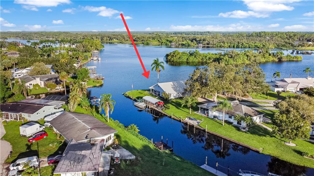 Aerial view of home on the river and wide canal at side of home.  Oversized 1/3 acres lot and end of cul-de-sac.