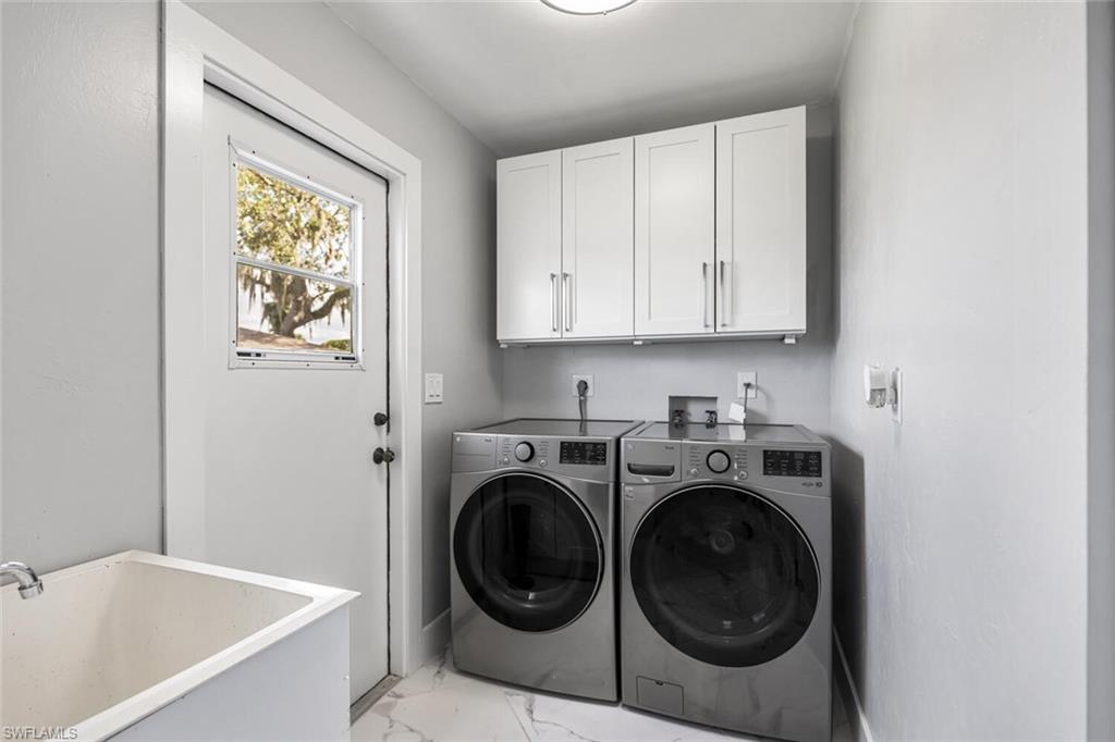 Laundry Room off of Kitchen has LG Full-Sized Washer and Dryer.  Laundry Tub. Side door to backyard.