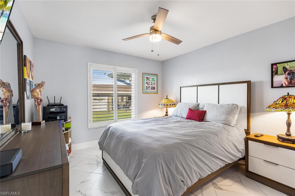 Spacious guest bedroom with closet.  View is to side yard.