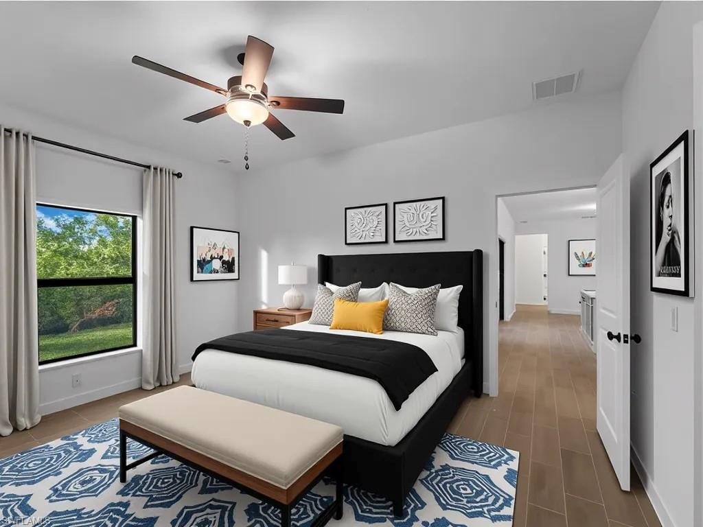 Virtually staged Bedroom featuring a ceiling fan and baseboards