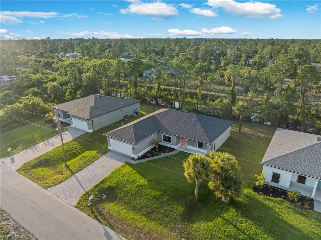 View of subject property with a heavily wooded area