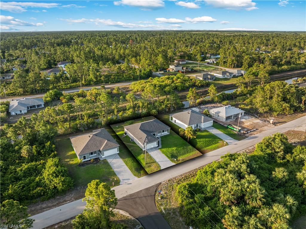 Aerial view of residential area featuring a heavily wooded area