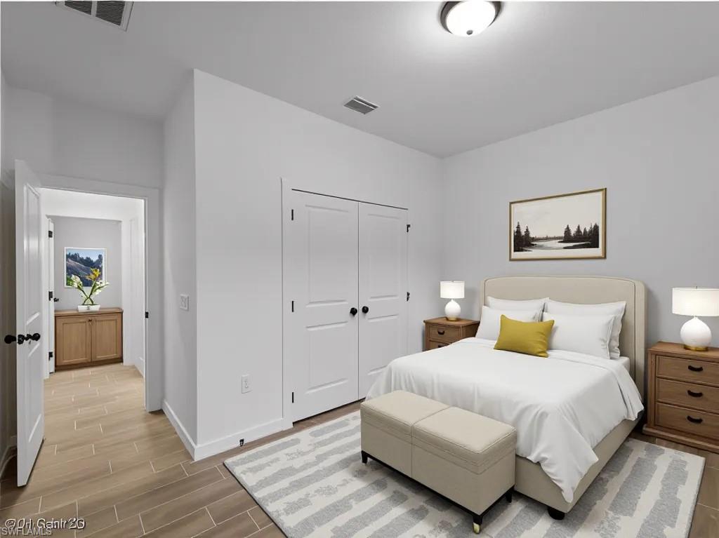 Virtually staged Bedroom with wood finish floors and a closet
