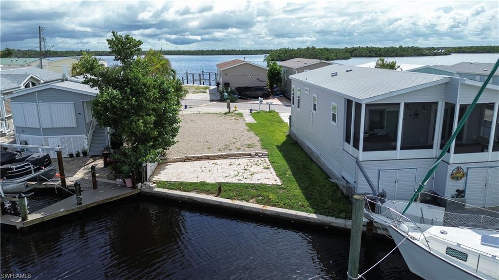 View of dock featuring a yard and a water view