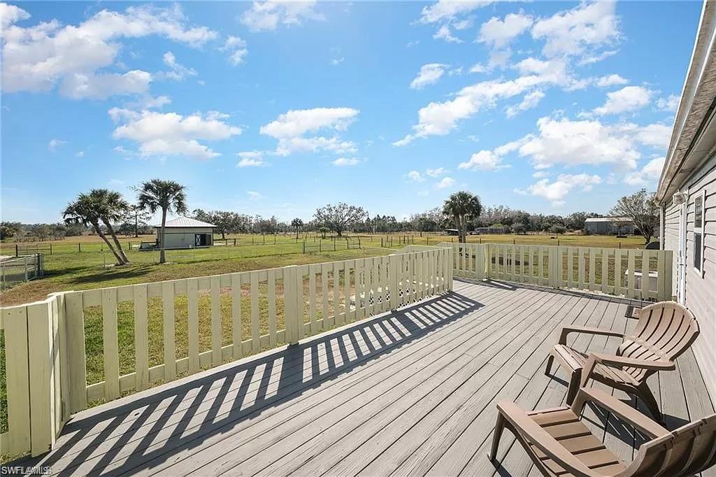 Deck with a yard and a rural view