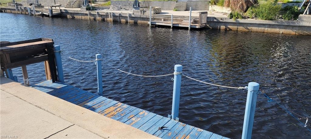 Dock area featuring a water view