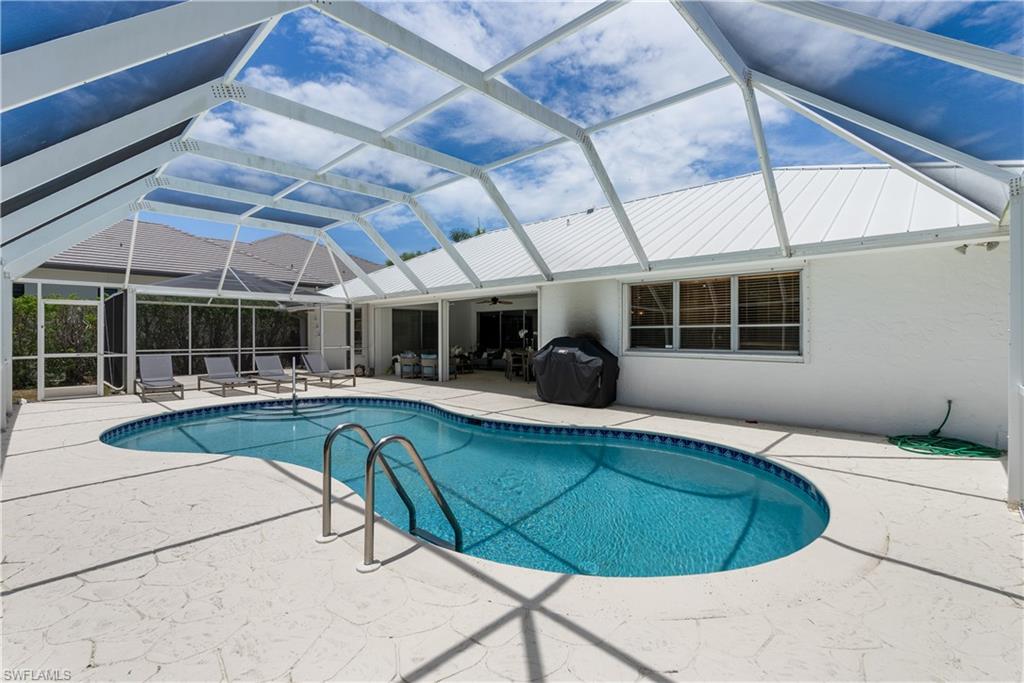 View of pool with a lanai and a patio area