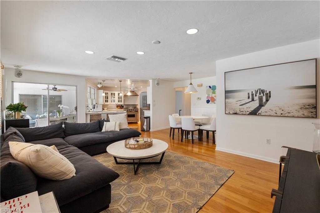 Living room featuring ceiling fan and hardwood / wood-style floors