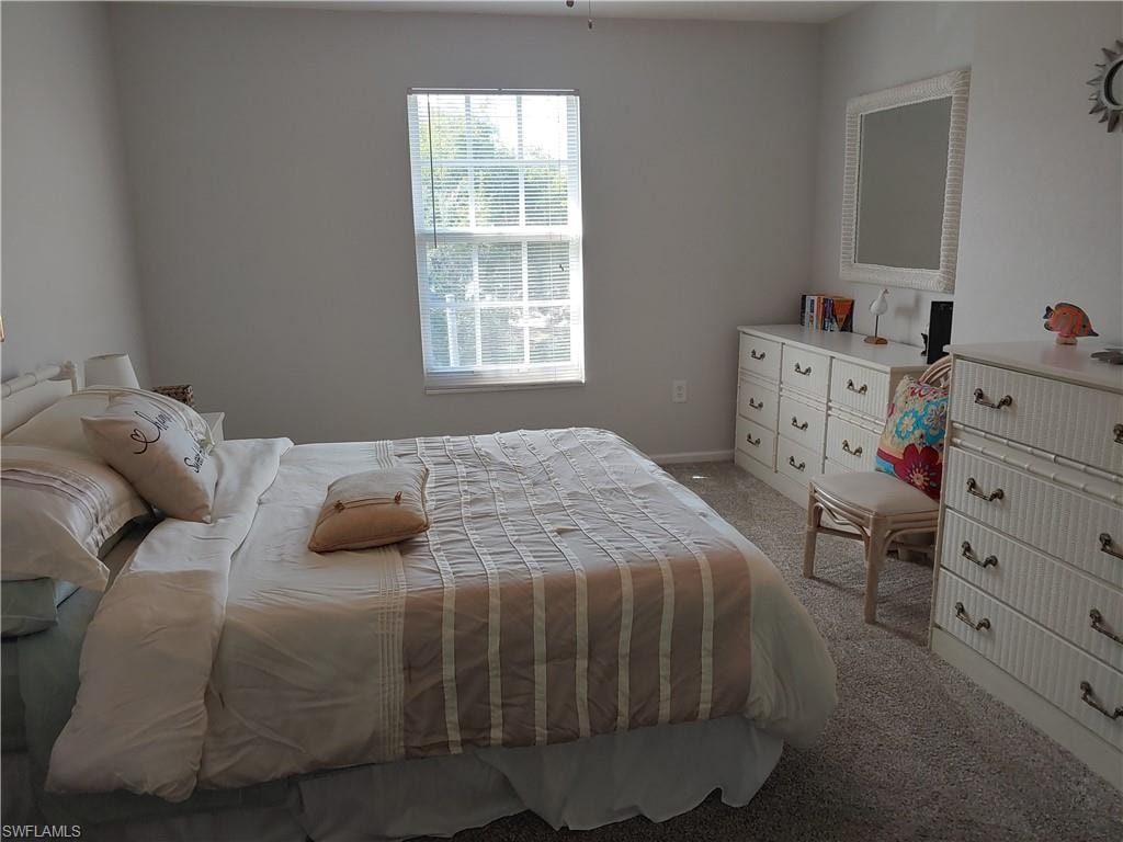 Bedroom featuring light colored carpet