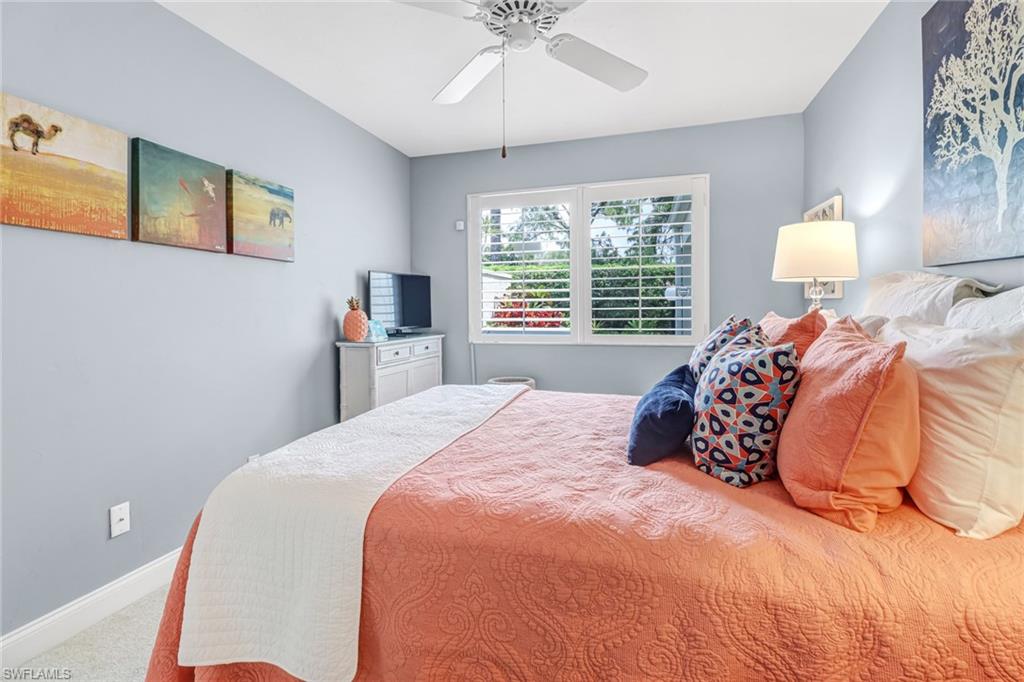 Carpeted bedroom featuring ceiling fan