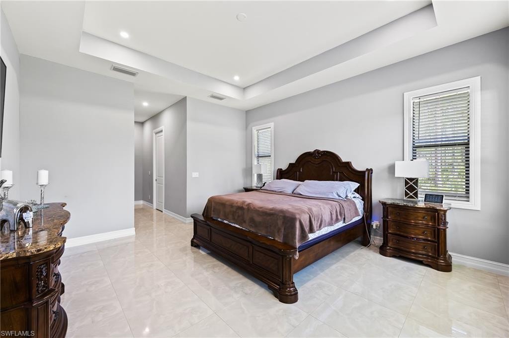 Tiled bedroom with a tray ceiling