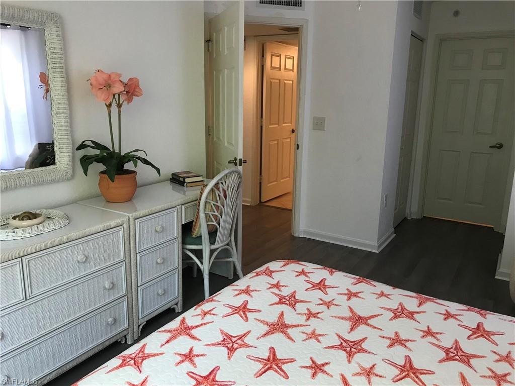 Bedroom with dark hardwood / wood-style floors