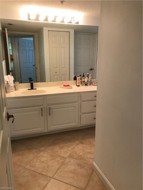 Bathroom featuring tile floors and vanity