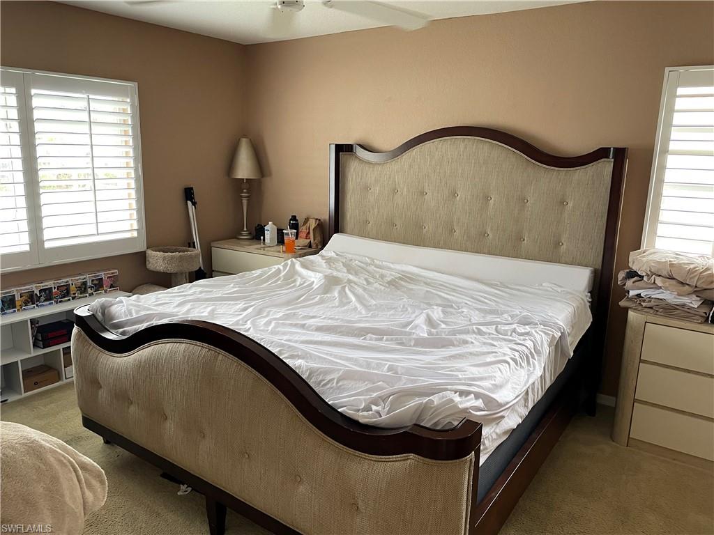 Carpeted bedroom with ceiling fan