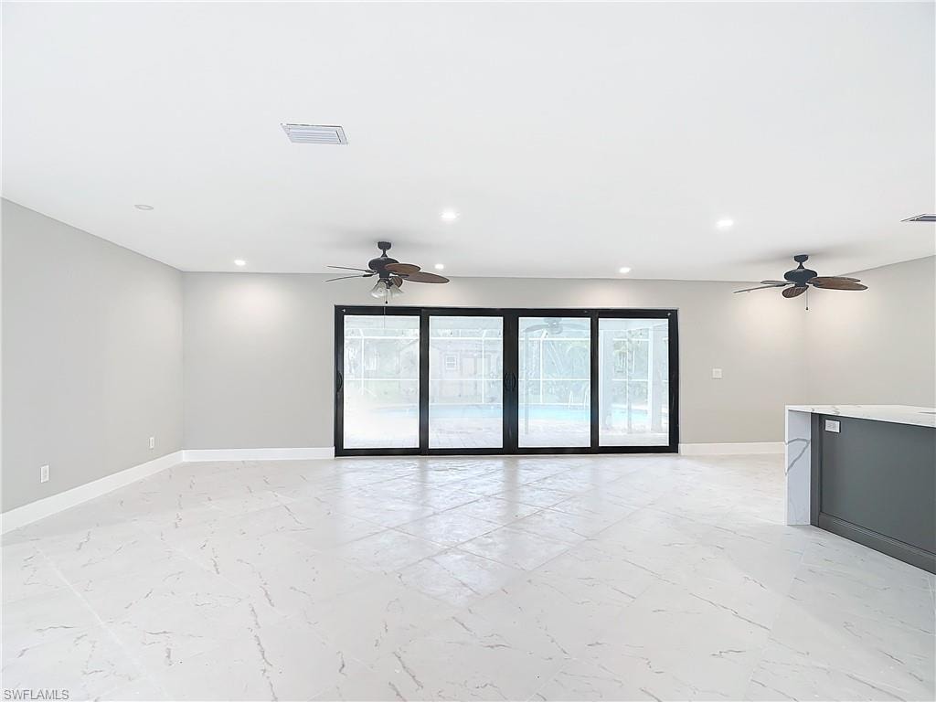Tiled empty room featuring ceiling fan