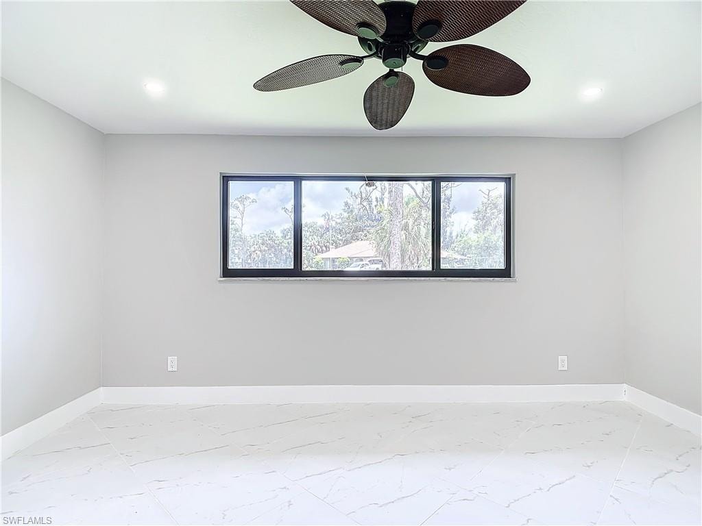 Empty room featuring ceiling fan