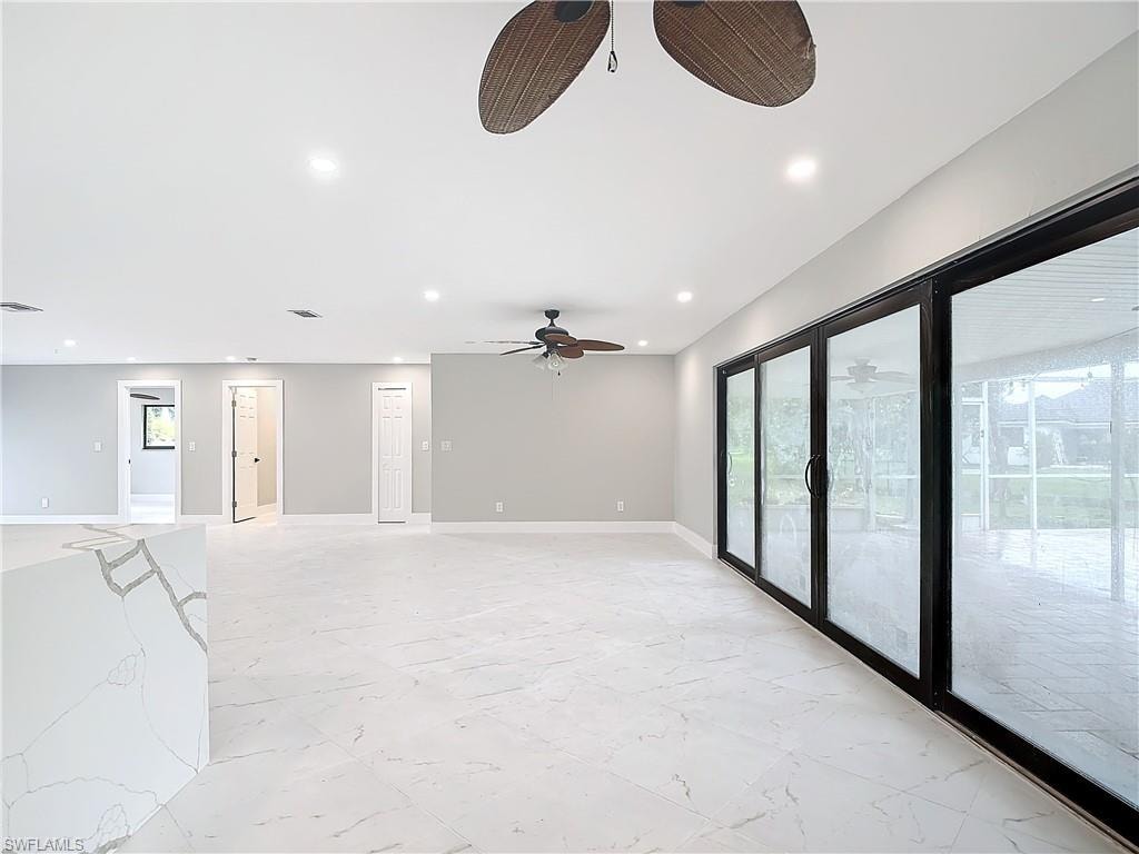 Tiled spare room with french doors and ceiling fan
