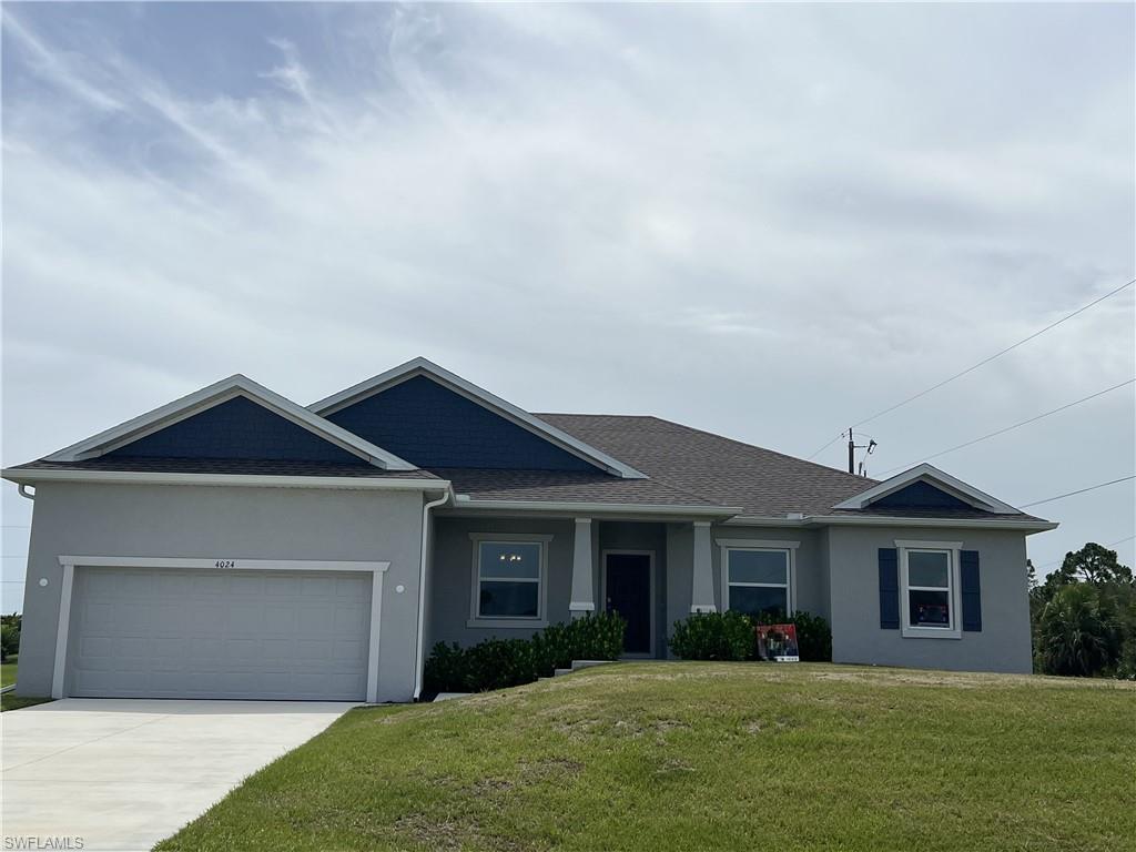 Ranch-style home featuring a garage, a front yard, stucco siding, concrete driveway, and a shingled roof