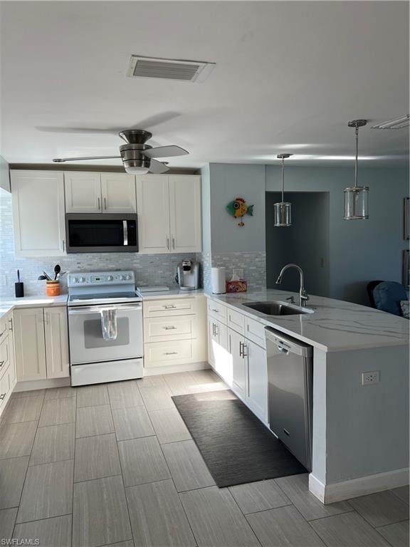 Kitchen with sink, dishwasher, stove, and tasteful backsplash