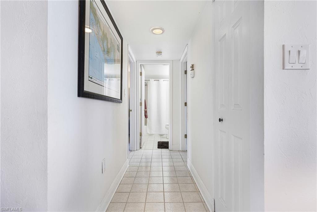 Hallway featuring light tile patterned floors