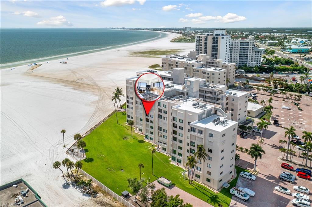 Aerial view with a water view and a view of the beach