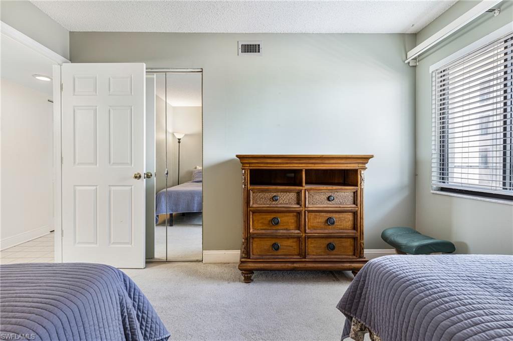 Carpeted bedroom with a closet
